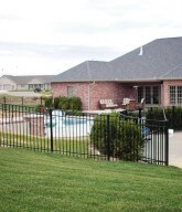 Photo of a residential fence around a pool.