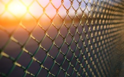 Chain Link Fence in Peoria IL with the sun setting behind it