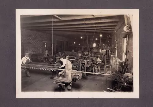 The inside of a workshop used for producing chain link fence mesh in Central Illinois